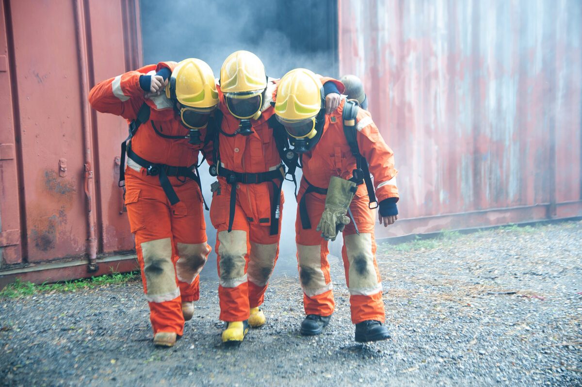 A fire crew shouldering a teammate during training