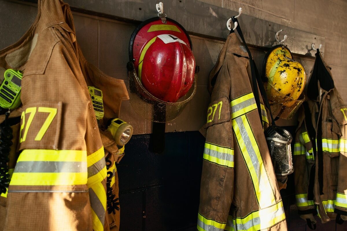 Turnout coats and helmets racked at a fire station